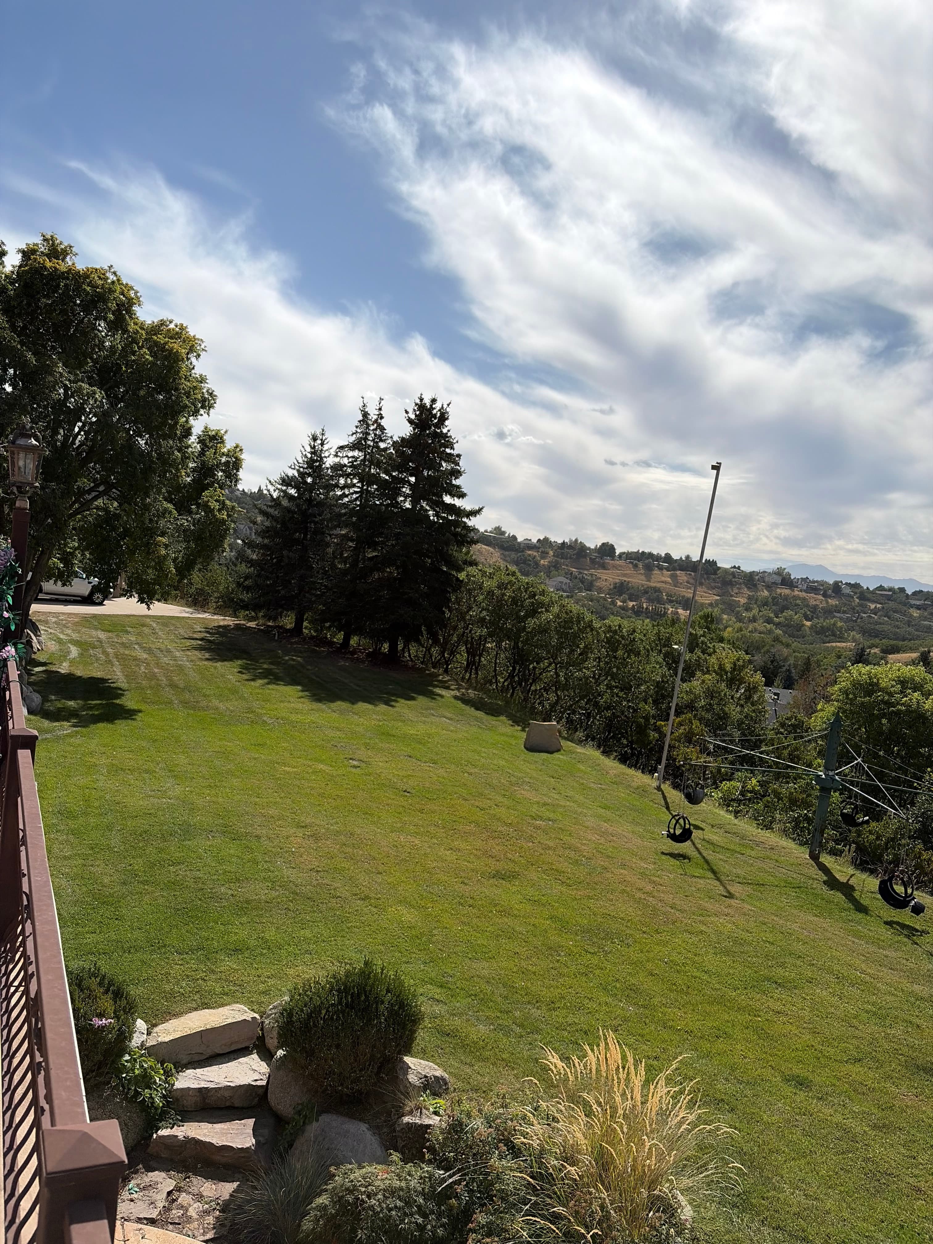 Large mowed hillside backyard with a valley view